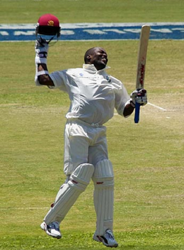 Lara raising bat after completing his Double century in 257 balls