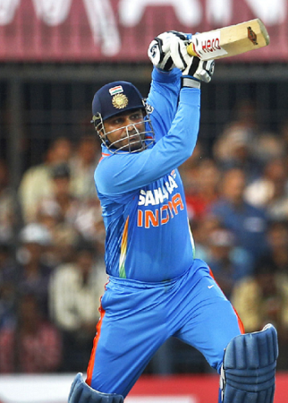 Virender Sehwag hitting the ball hard to reach his 150