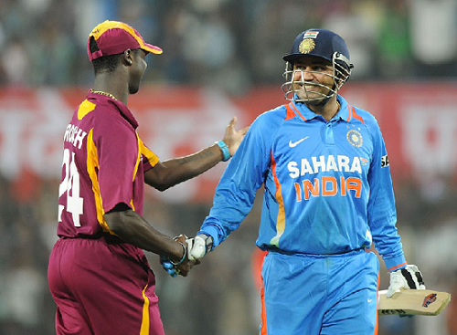 Virender Sehwag is congratulated by Kemar Roach while walking off